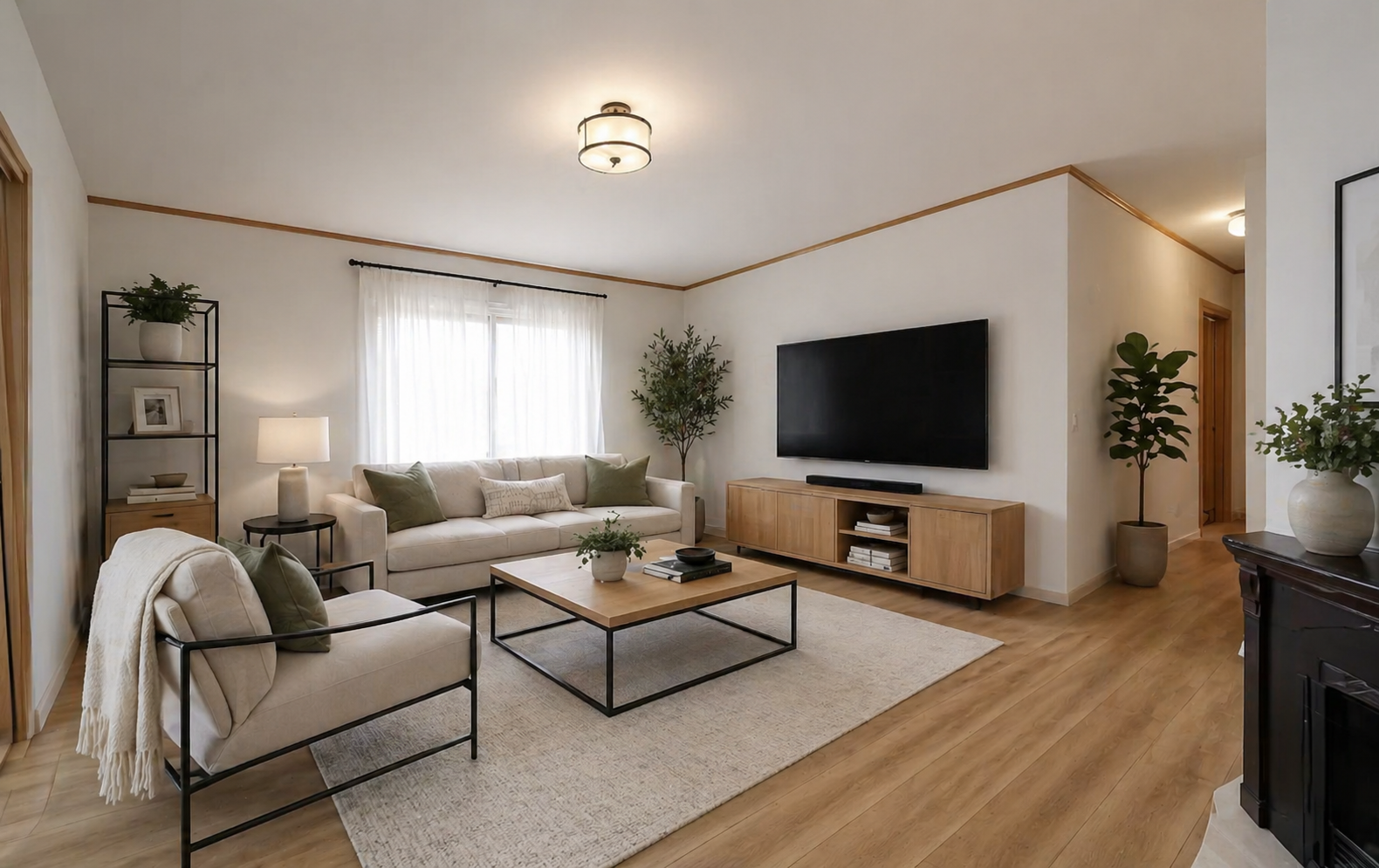 Staged family room with hardwood floors, neutral sectional, and modern decor